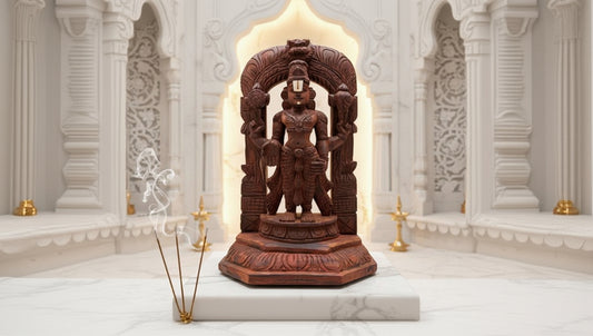 Carved wooden statue in a decorative setting with white marble walls.